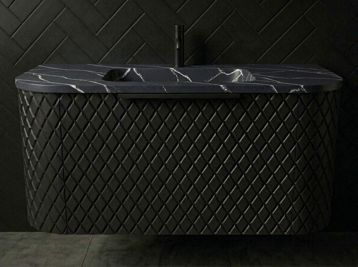 Maryfass Black Diamond Corian bathroom vanity with geometric textured facade and integrated seamless sink against a white tiled wall.